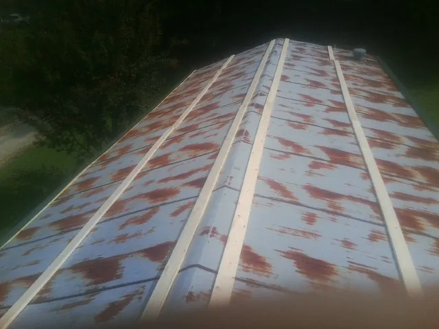 Rusted metal roof panels with new wood purlins before replacement — Storm Damage Roof Repair in Hartford by Roofing Brothers