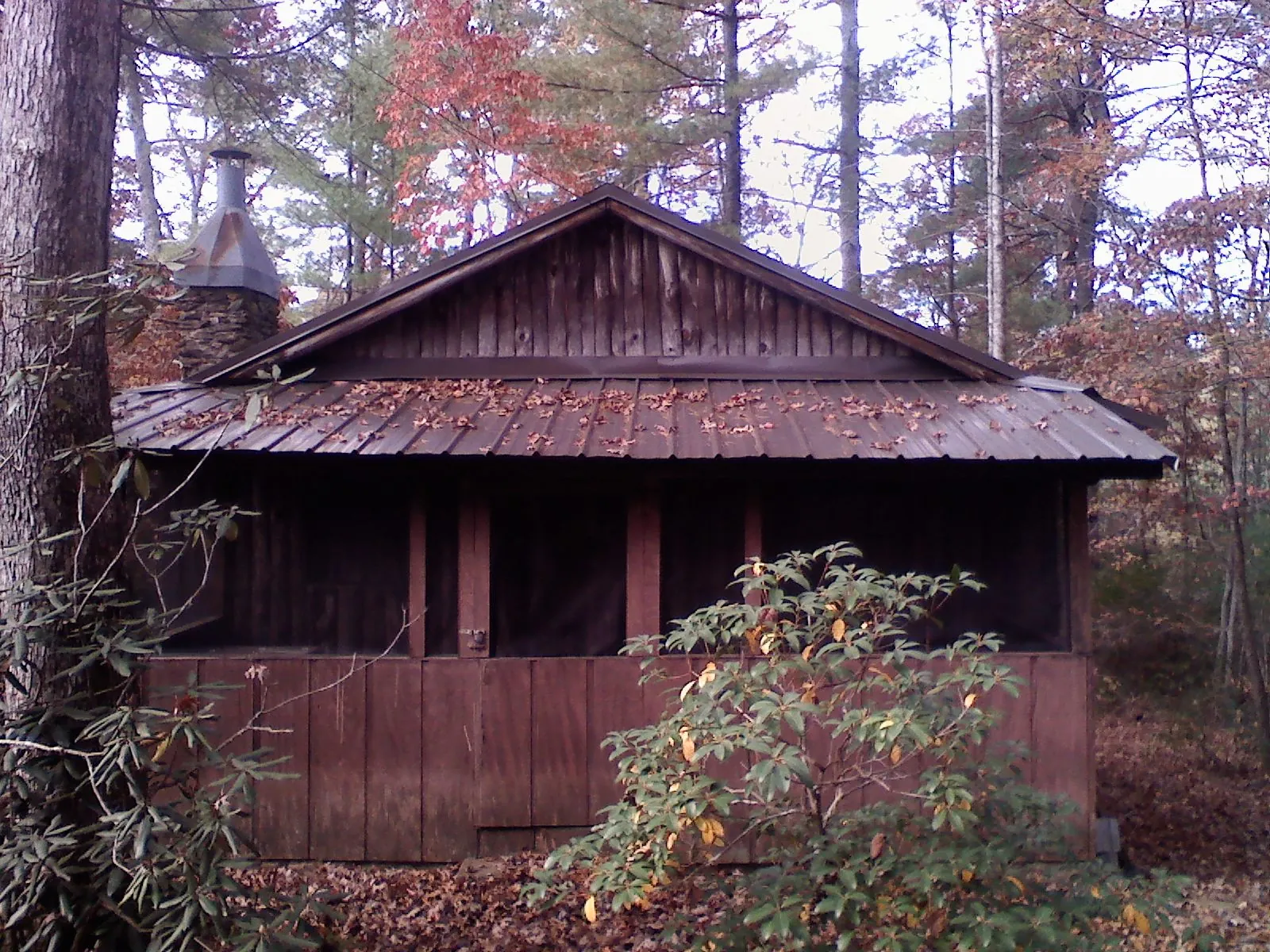 Metal roof over the screened porch of a rustic cabin in Hartford