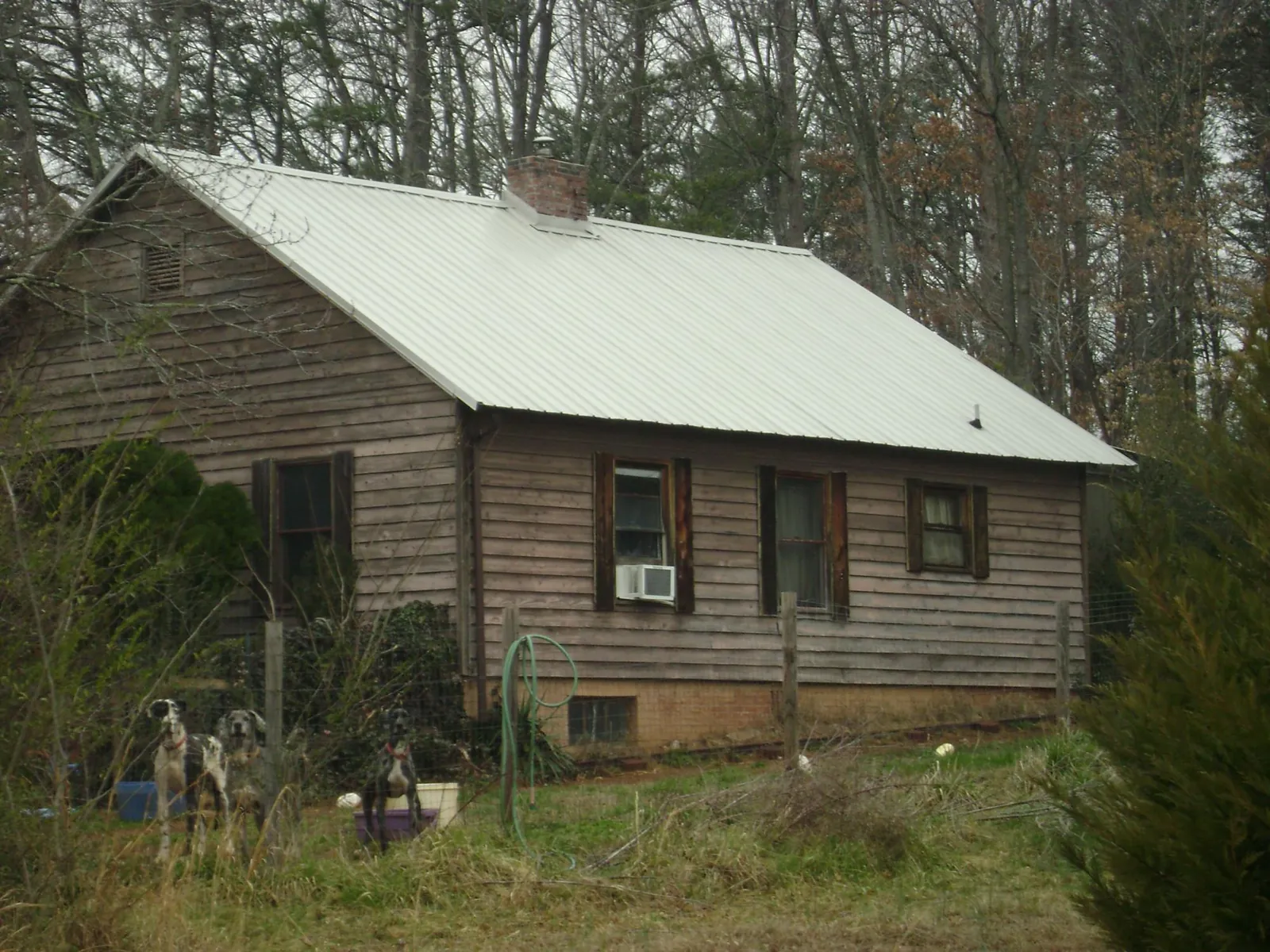White metal roof on an old wood sided farmhouse, from a Asphalt Shingle Roof Repair job in Hartford
